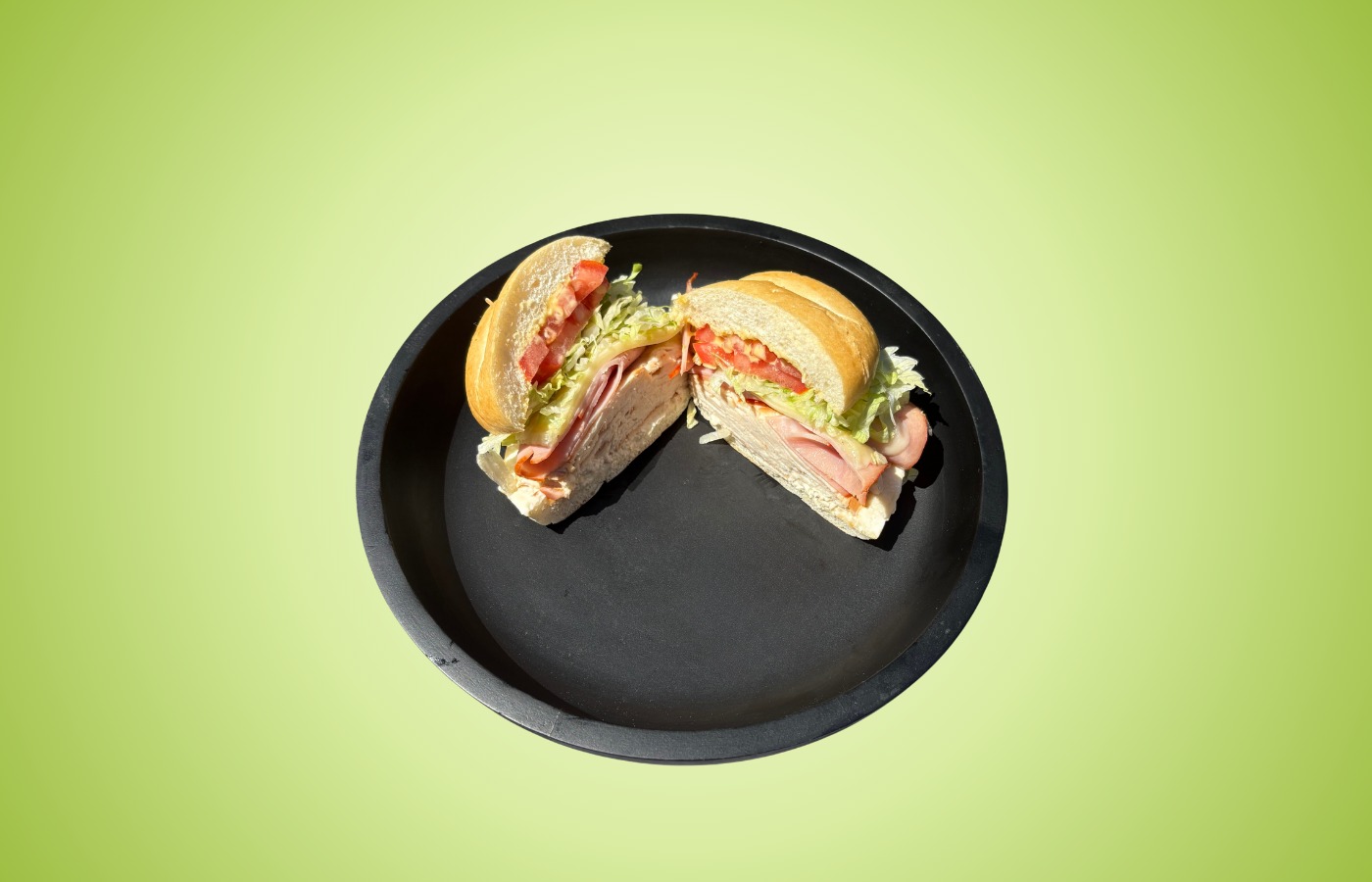 Chicken Cordon Bleu sandwich with chicken, ham, Swiss cheese, lettuce, tomato, and honey mustard on a toasted Kaiser roll