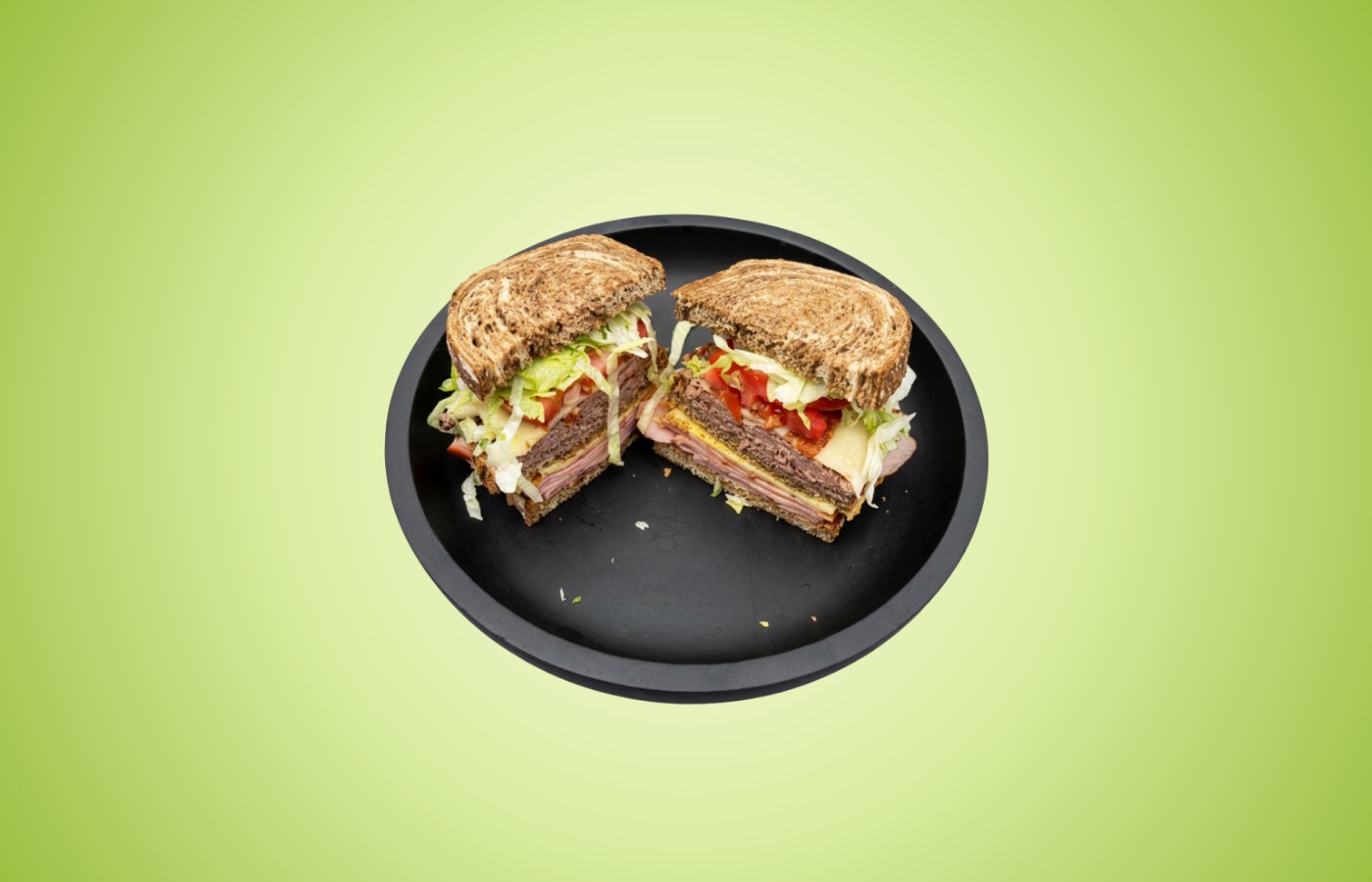 The Green Apple Club sandwich with ham, roast beef, bacon, Swiss, lettuce, tomato, onion, cilantro mayo, and whole grain mustard on marbled rye