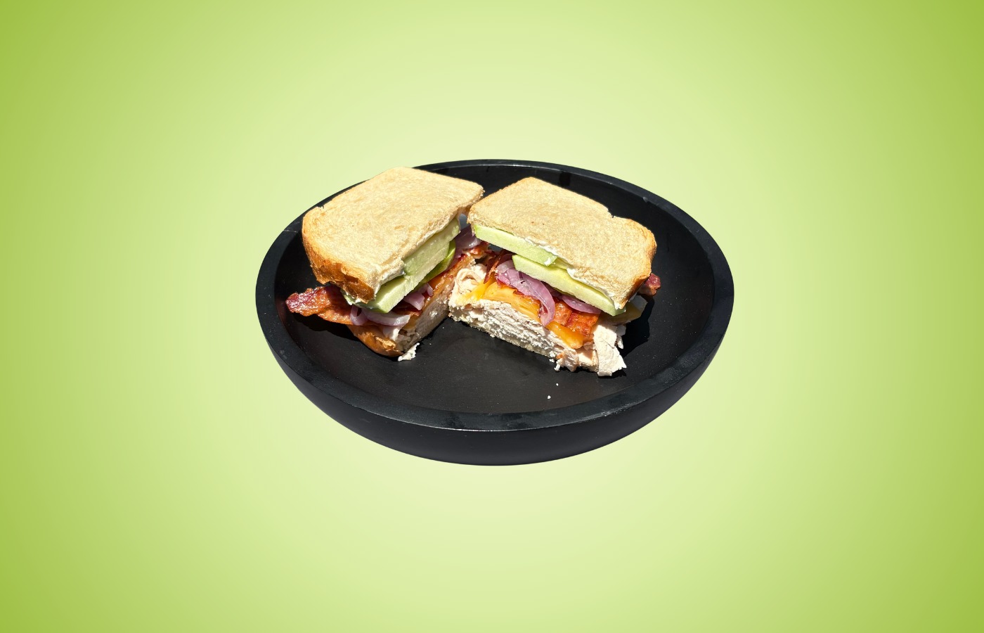The Green Apple signature sandwich on toasted sourdough with turkey, bacon, smoked gouda, red onions, green apple slices, and cream cheese