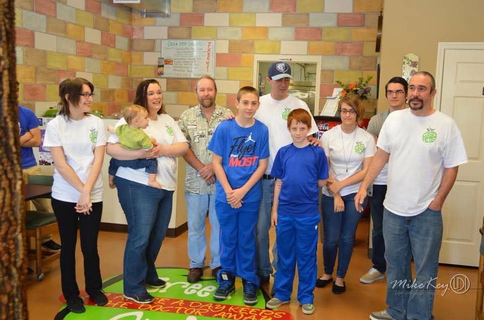 Original Green Apple family and staff